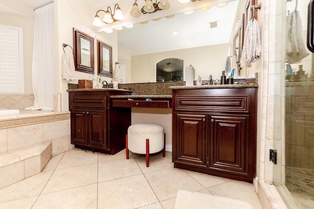 bathroom featuring an enclosed shower, vanity, and tile patterned floors