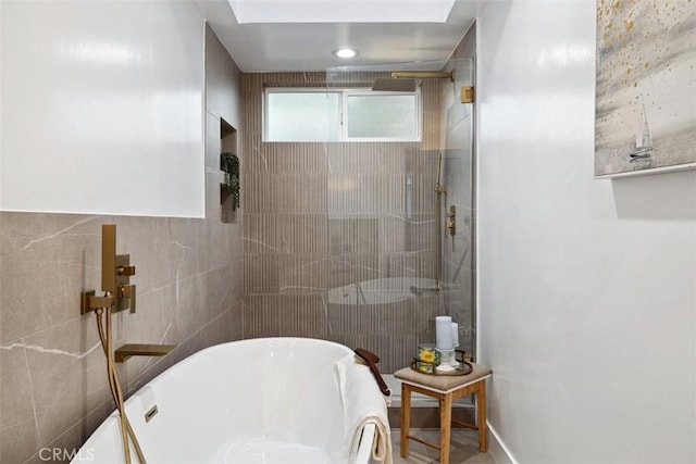 bathroom featuring shower with separate bathtub