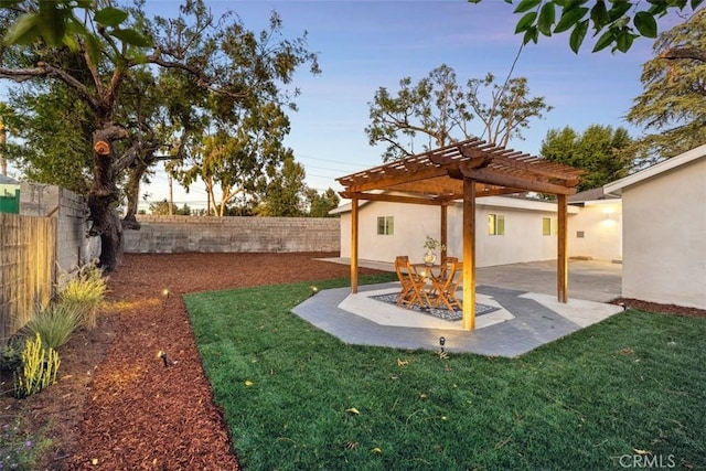 yard at dusk with a pergola and a patio area