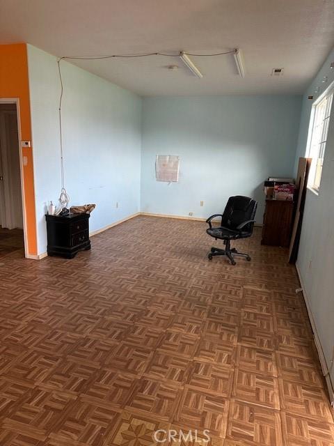 unfurnished room featuring parquet flooring