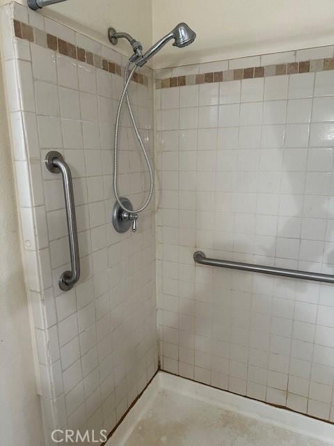 bathroom with tiled shower