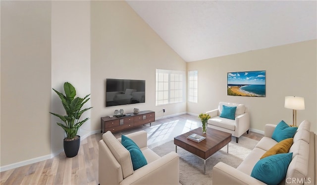 living room with high vaulted ceiling and light hardwood / wood-style floors