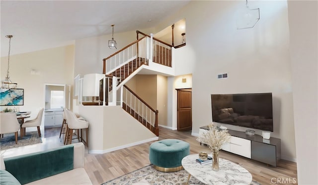 living room with hardwood / wood-style flooring and a high ceiling