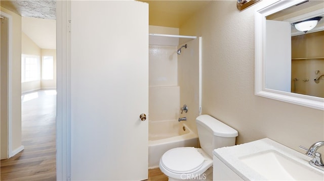 full bathroom with vanity, hardwood / wood-style flooring, tub / shower combination, and toilet