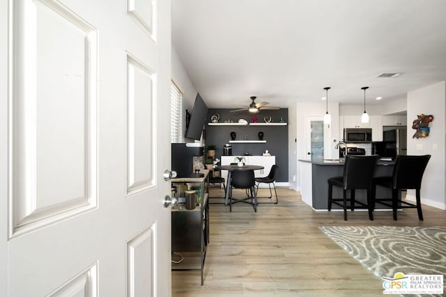 office space featuring ceiling fan and light hardwood / wood-style flooring