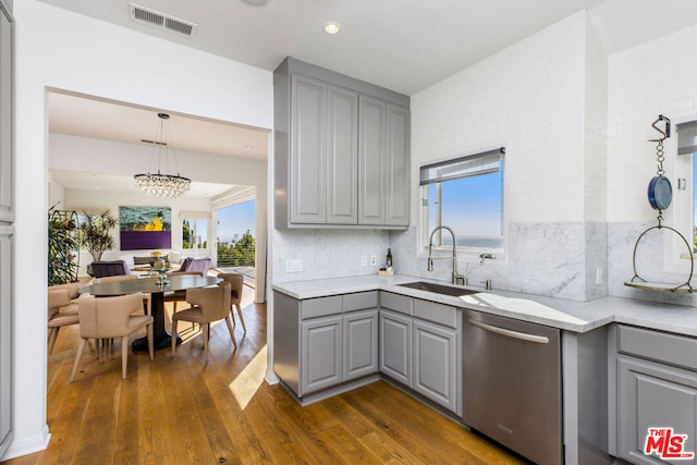 kitchen with sink, dishwasher, a healthy amount of sunlight, and gray cabinetry