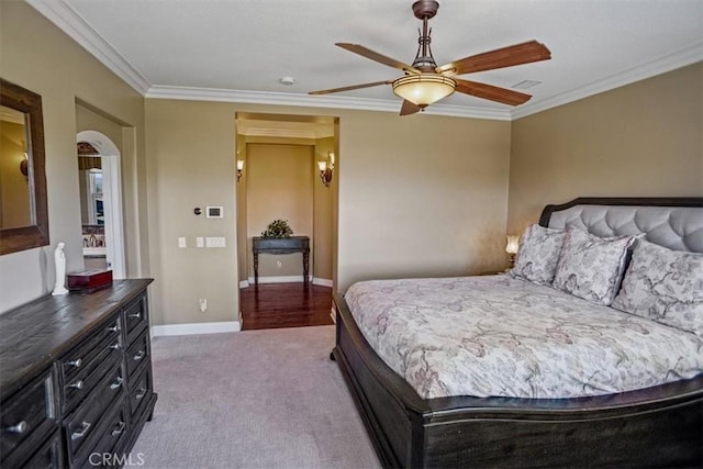 bedroom with carpet floors, ceiling fan, and crown molding