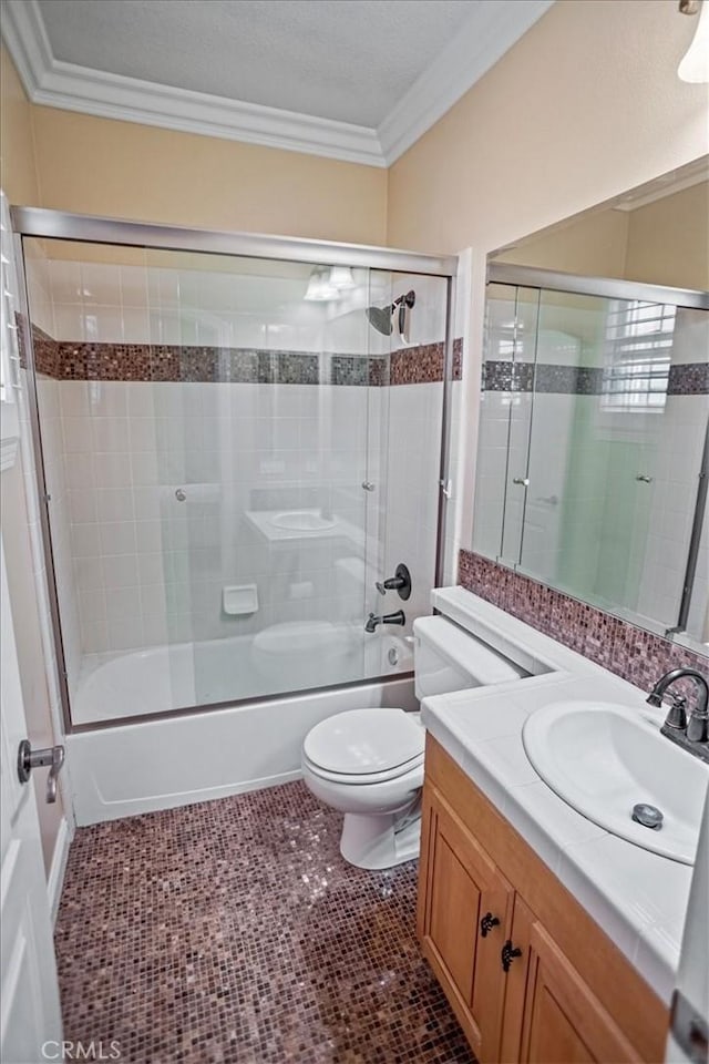 full bathroom featuring bath / shower combo with glass door, ornamental molding, tile patterned floors, and vanity