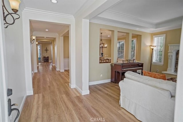 interior space with ornamental molding, light hardwood / wood-style floors, and a notable chandelier