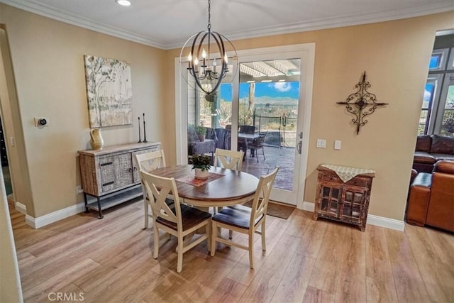 dining room with crown molding, light hardwood / wood-style floors, and plenty of natural light