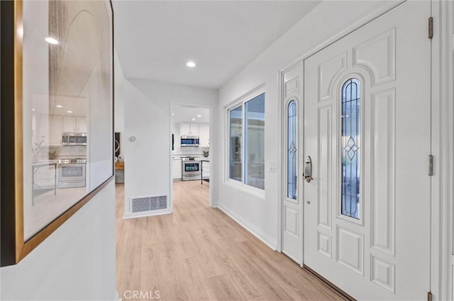 foyer with light hardwood / wood-style floors