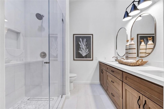 bathroom featuring toilet, a shower with door, and vanity