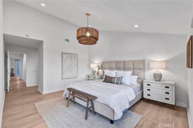 bedroom featuring lofted ceiling and light hardwood / wood-style flooring