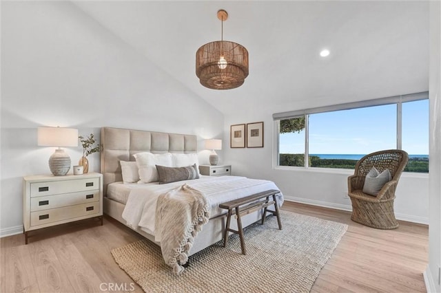 bedroom featuring high vaulted ceiling and light hardwood / wood-style floors