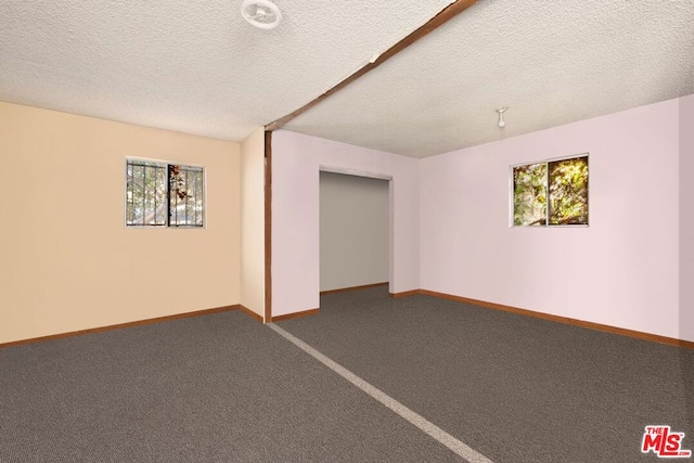 basement featuring a textured ceiling and carpet floors