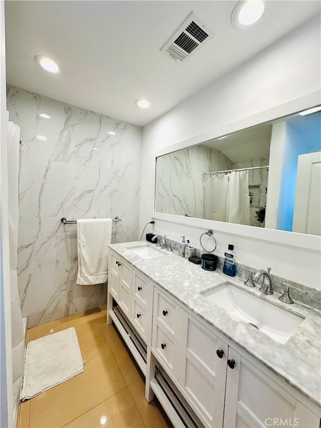 bathroom with tile patterned flooring, tile walls, a shower with curtain, and vanity