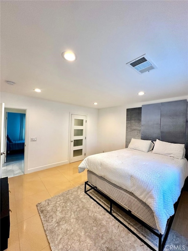 bedroom with light tile patterned floors