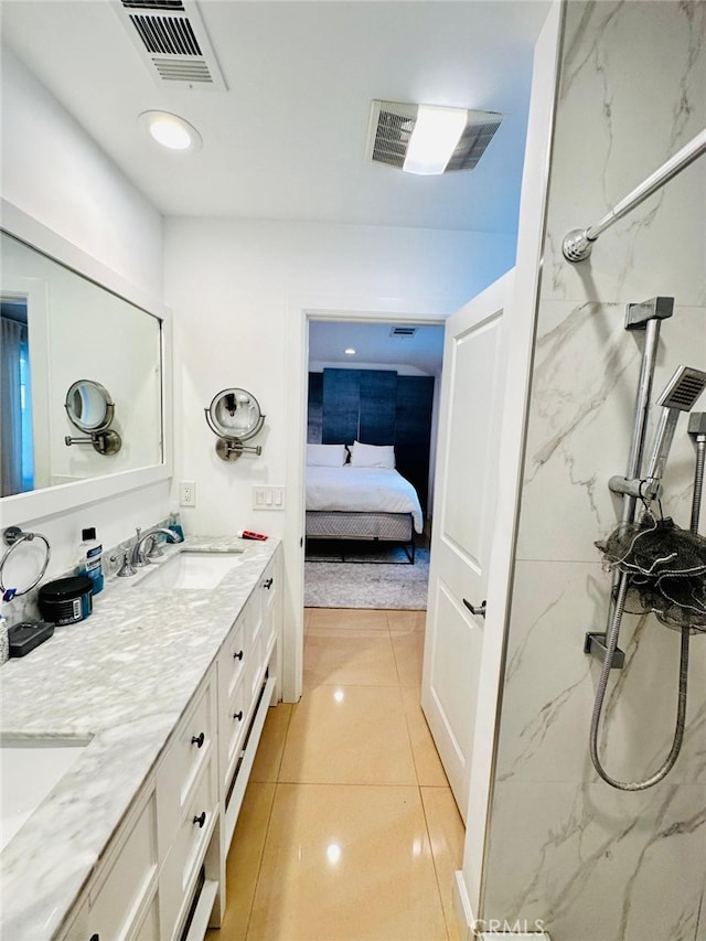 bathroom featuring walk in shower, vanity, and tile patterned floors