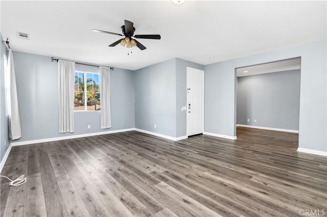 unfurnished room featuring visible vents, baseboards, wood finished floors, and a ceiling fan