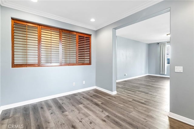 unfurnished room with recessed lighting, wood finished floors, baseboards, and ornamental molding