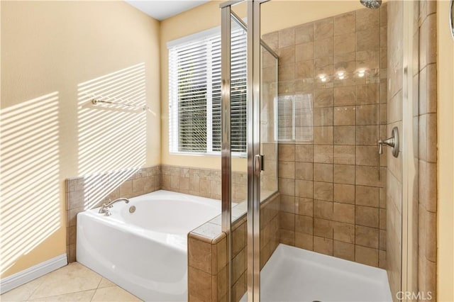 full bathroom featuring tile patterned flooring, a shower stall, and a garden tub