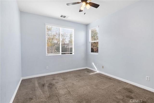 empty room featuring visible vents, a ceiling fan, carpet, and baseboards