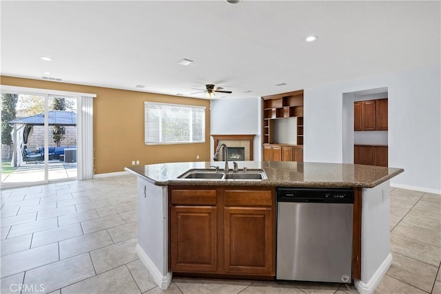 kitchen with a sink, a wealth of natural light, stainless steel dishwasher, and open floor plan