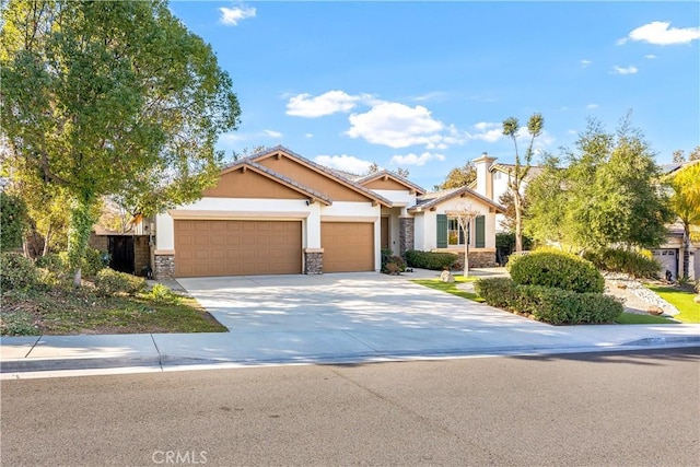 craftsman house featuring stone siding, stucco siding, concrete driveway, and a garage