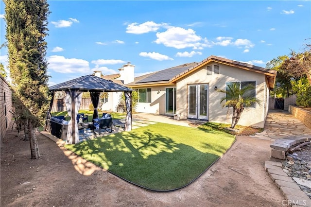 back of house featuring an outdoor living space, stucco siding, french doors, a fenced backyard, and a patio