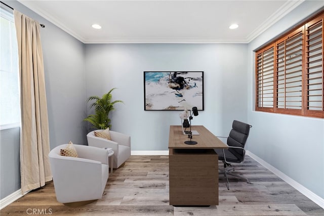 office space with ornamental molding, baseboards, and wood finished floors