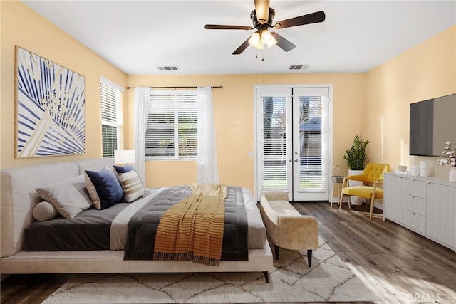 bedroom featuring ceiling fan, visible vents, wood finished floors, and access to exterior