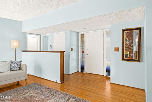 living room featuring wood-type flooring and a textured ceiling