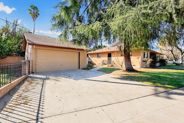 single story home featuring a garage and a front lawn