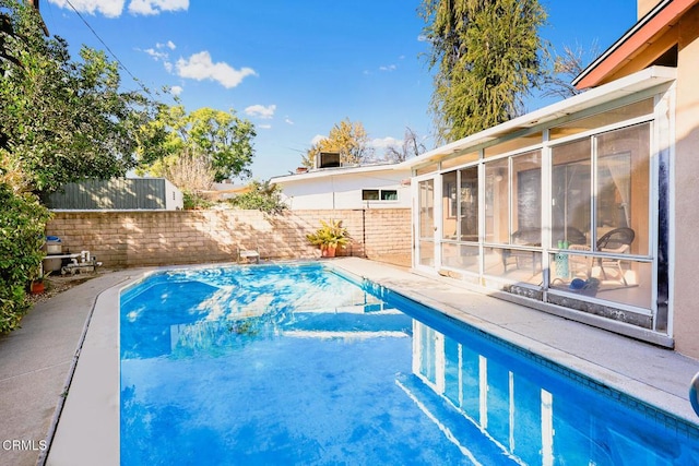 view of pool featuring a sunroom