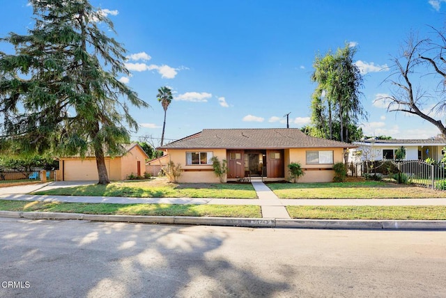 single story home featuring a front yard and a garage