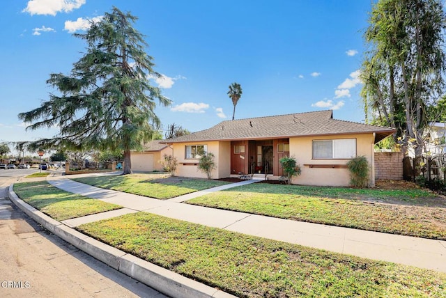 single story home with a front yard and a garage