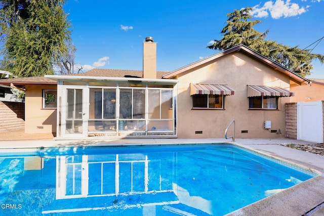 view of swimming pool with a sunroom