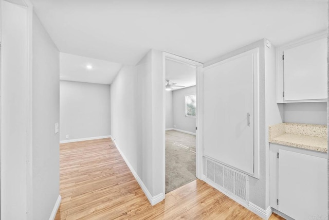 corridor with light hardwood / wood-style flooring