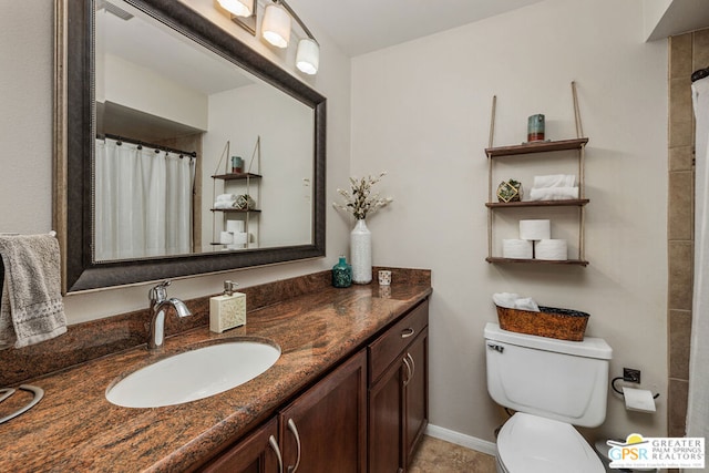 bathroom featuring toilet, vanity, and walk in shower