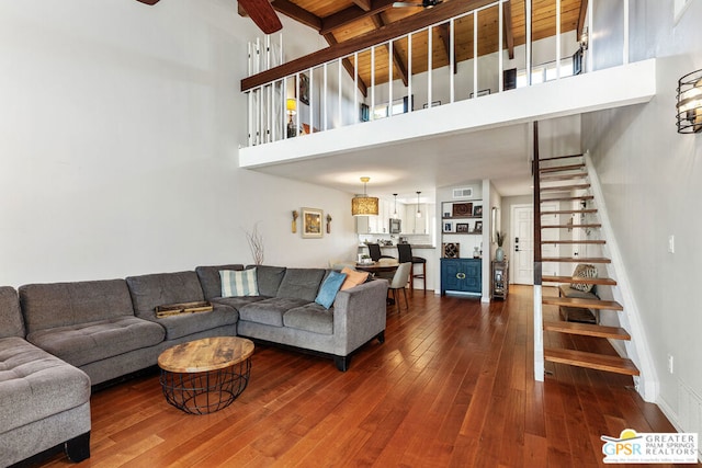 living room featuring a high ceiling and hardwood / wood-style flooring