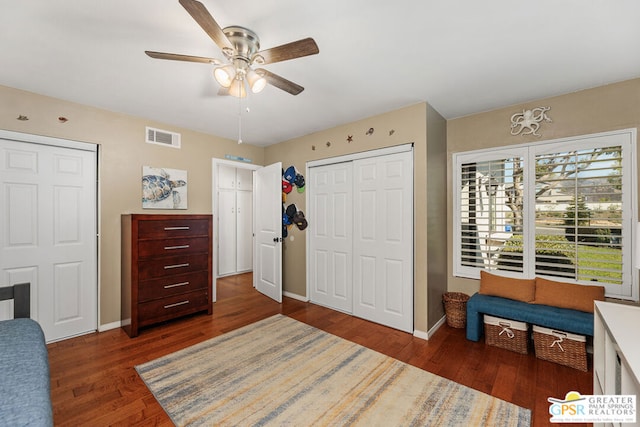 bedroom with ceiling fan and dark wood-type flooring