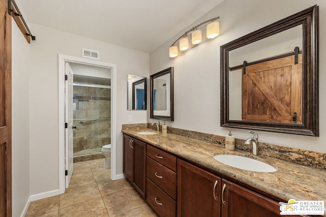 bathroom with toilet, vanity, tile patterned flooring, and an enclosed shower