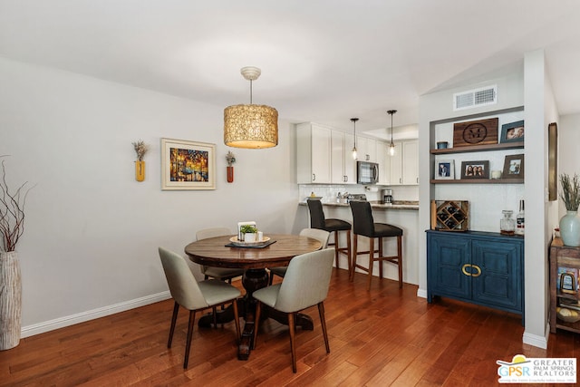 dining space with dark wood-type flooring