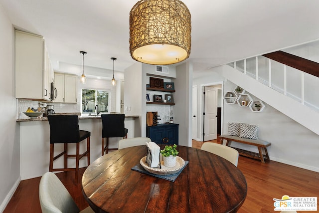 dining room featuring dark wood-type flooring and sink