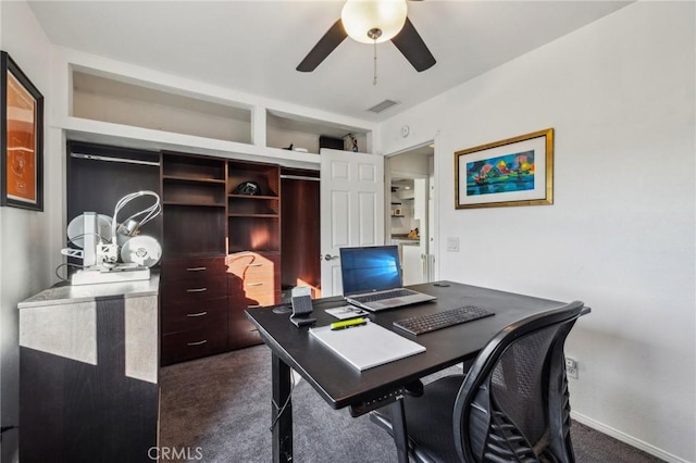 office space featuring ceiling fan and dark carpet