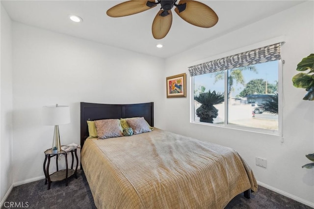 bedroom with ceiling fan and dark colored carpet