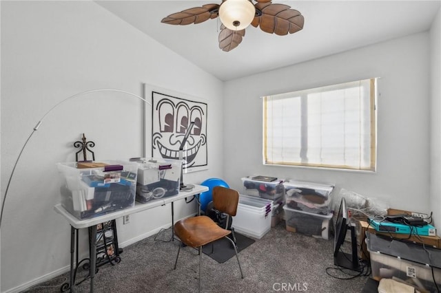 office area with vaulted ceiling, ceiling fan, and dark carpet