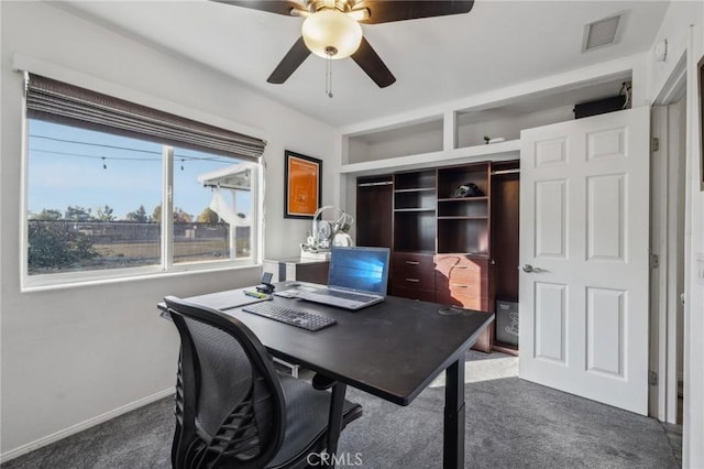 carpeted office space with ceiling fan