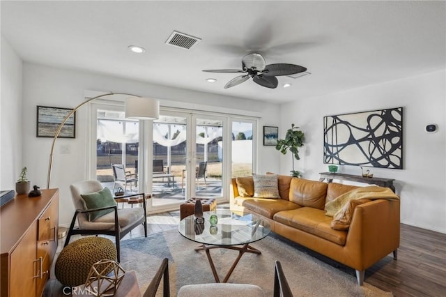 living room with ceiling fan and wood-type flooring