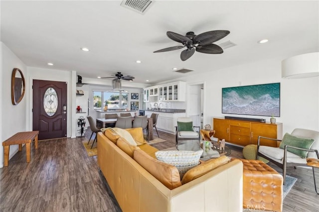 living room with ceiling fan, sink, and hardwood / wood-style floors